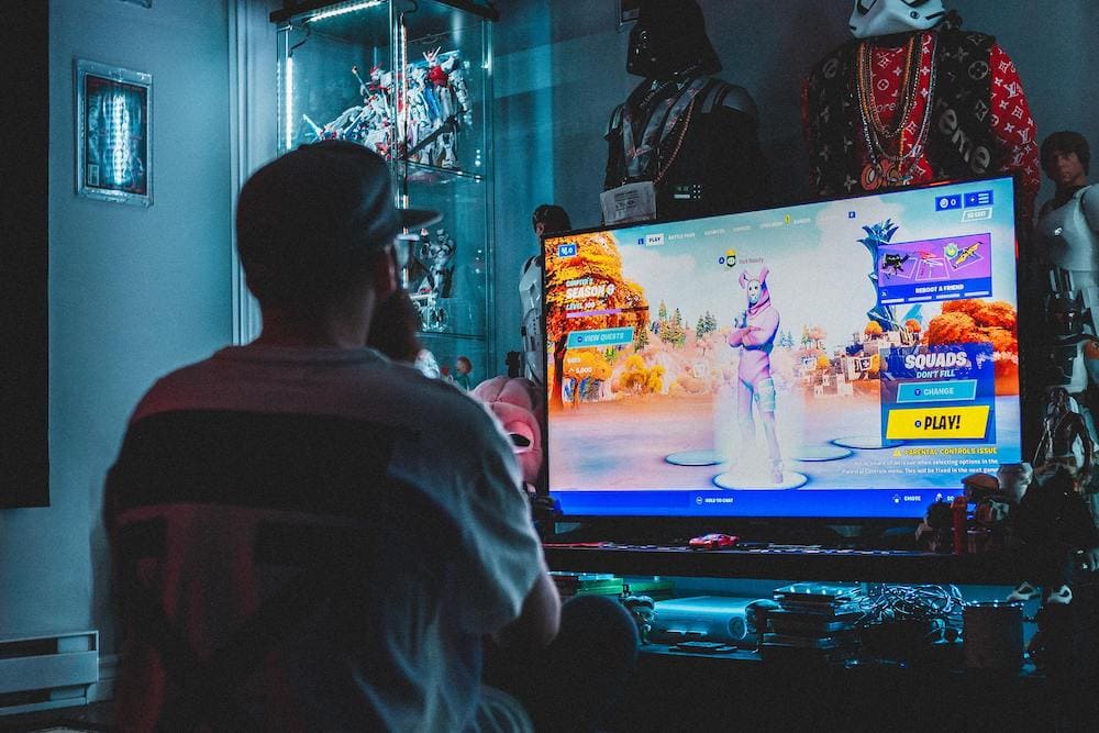 Image: A man up late at night playing video games.