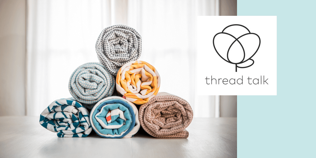 Image: A stack of 6 soft Thread Talk Blankets beside the Thread Talk logo