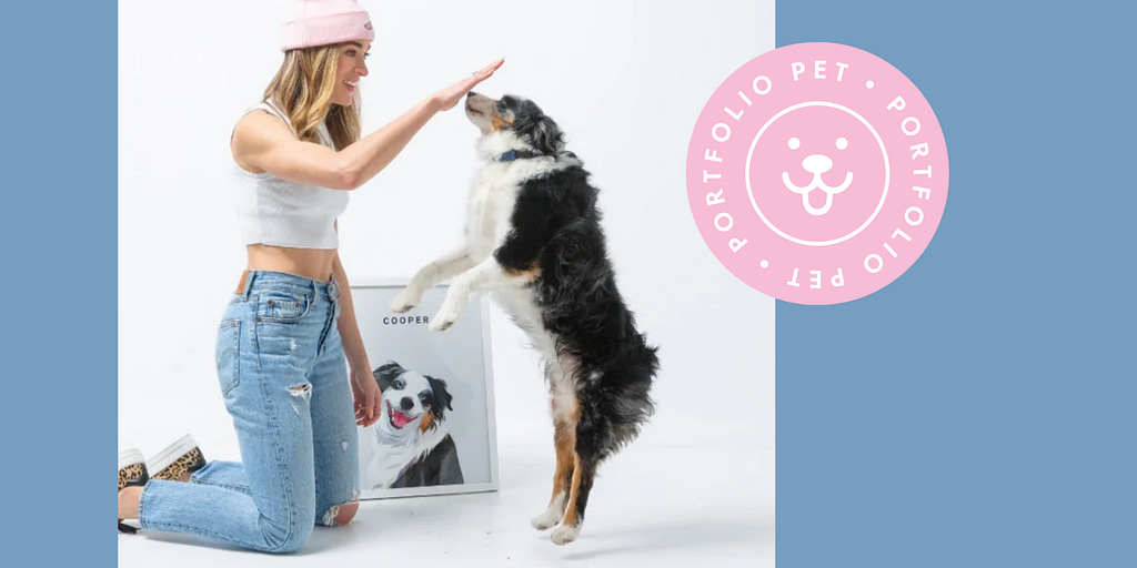 Image: A woman high-fiving her dog, standing in front of a portrait of the dog from Portfolio Pets