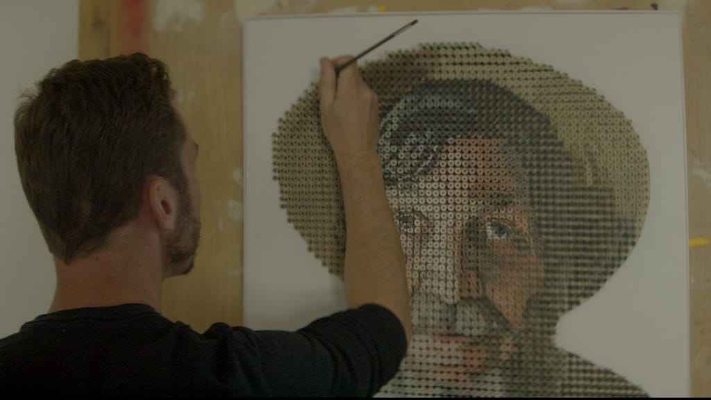 Image: Artist Andrew Meyers painting the portrait of George Wurtzel that's made of nails.