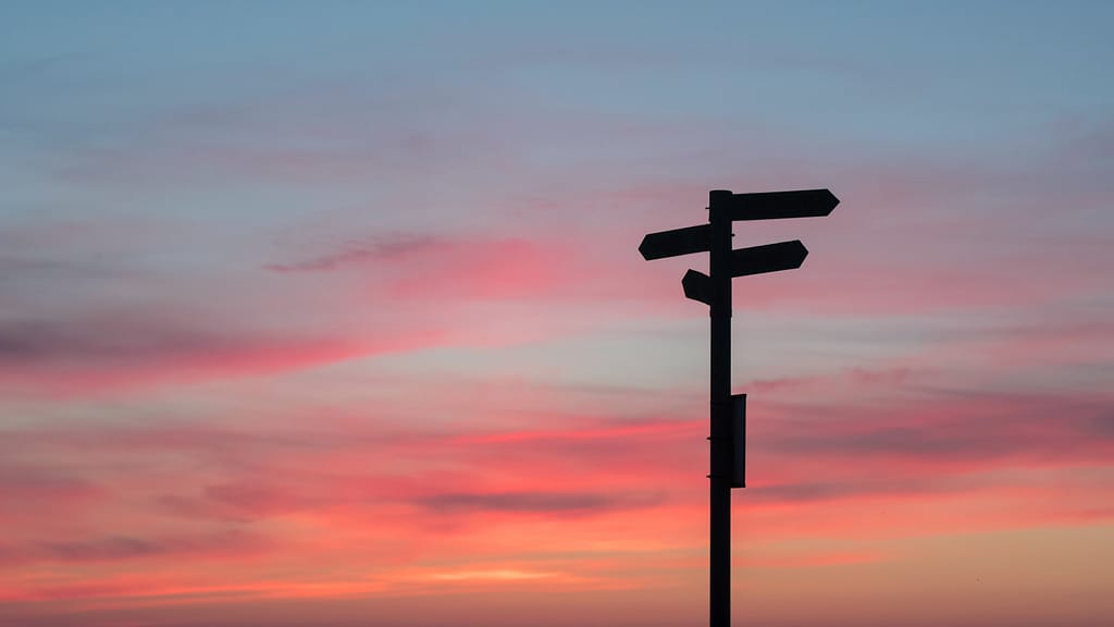 Image: A signpost with a sunset behind, a metaphor for moments that leave your life changed.