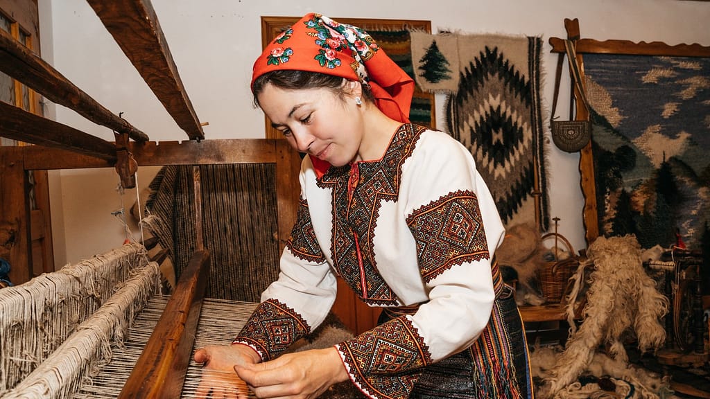 Image: Natalya Kishchuk, a Hutsul weaver from Ukraine weaves a traditional blanket on a loom