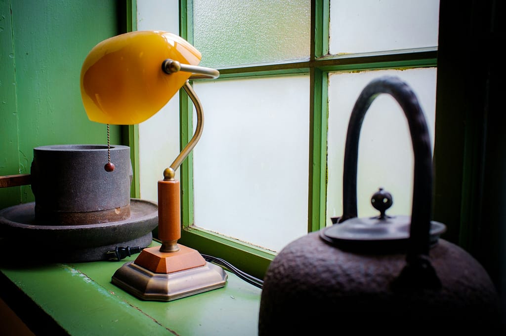 Image: Antique lamp sitting in a window sill