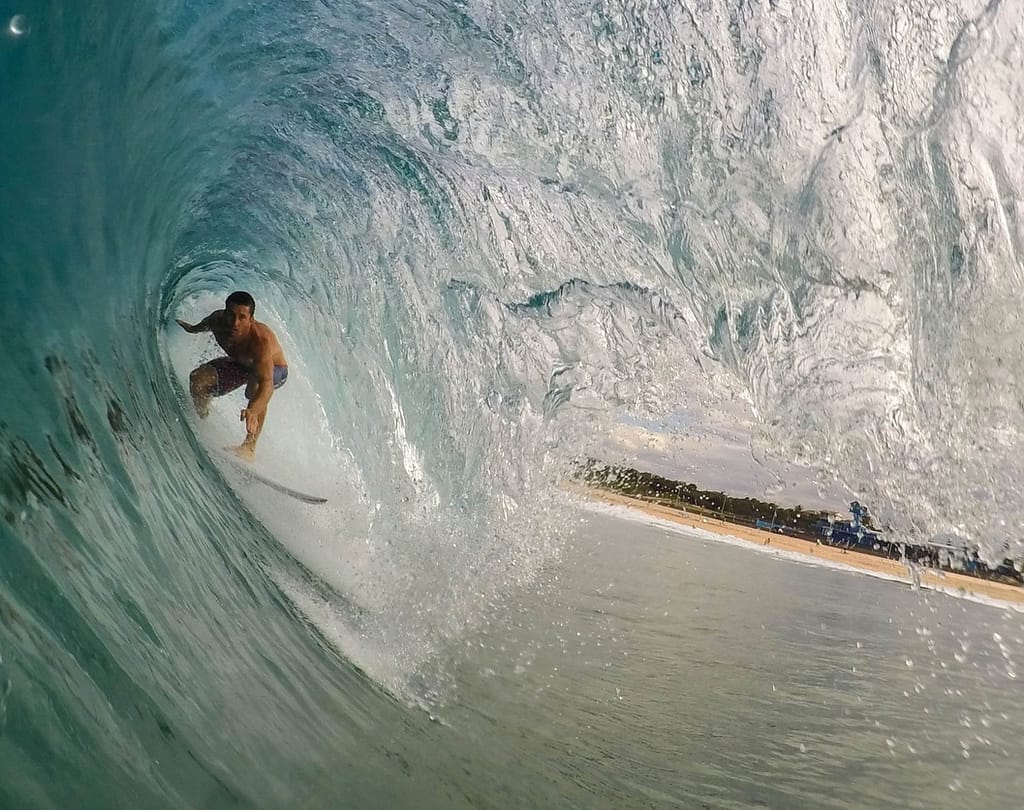 Image: A surfer "getting barreled"