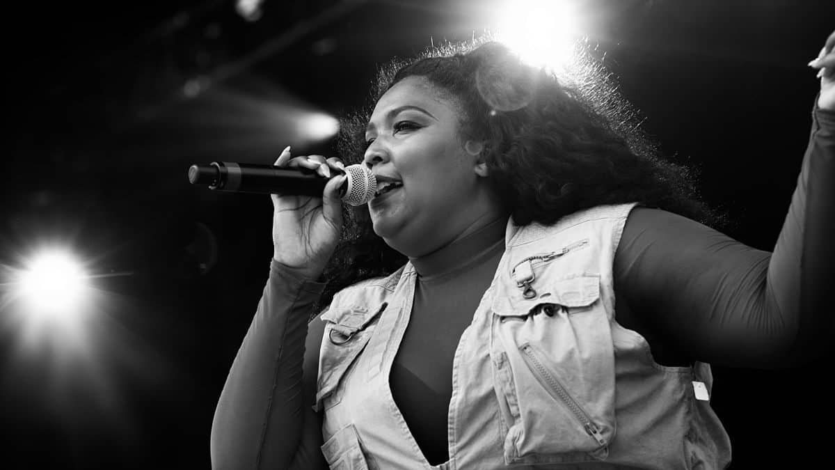Image: Black & white image of Lizzo performing