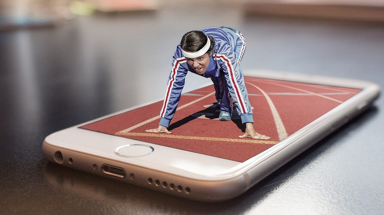 Image: Woman in a runners stance who looks like she's coming out of a phone screen
