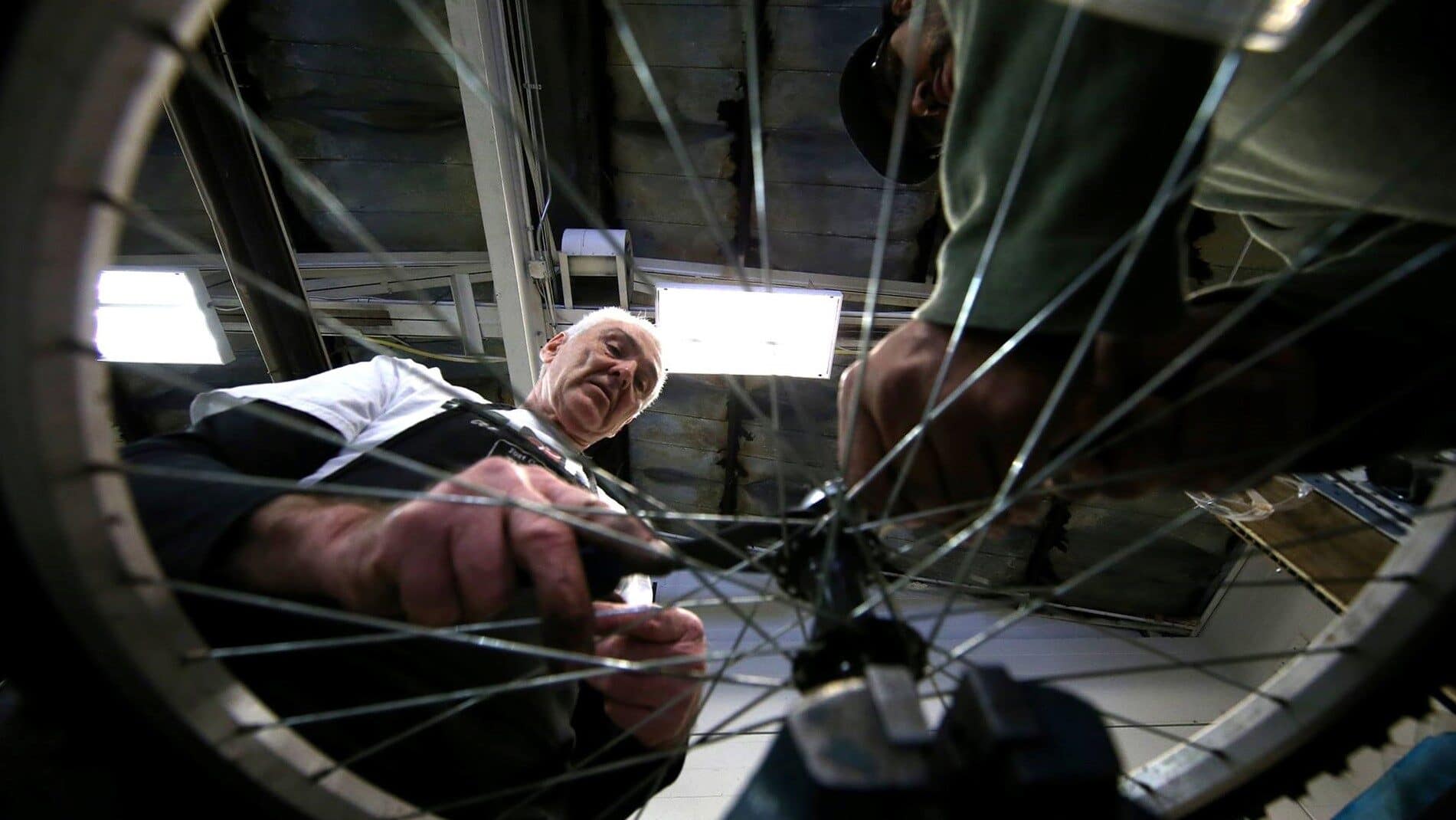 Image: older person working on a bike at the Fort Collins Bike Shop