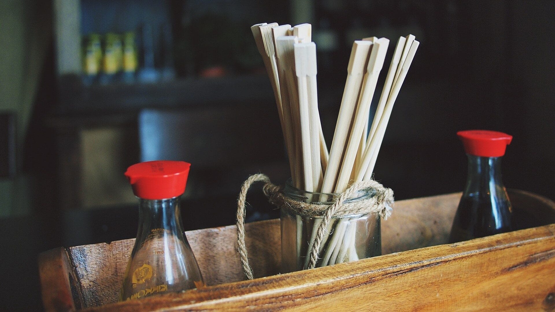Image: Chopsticks inside of a container with soy sauce