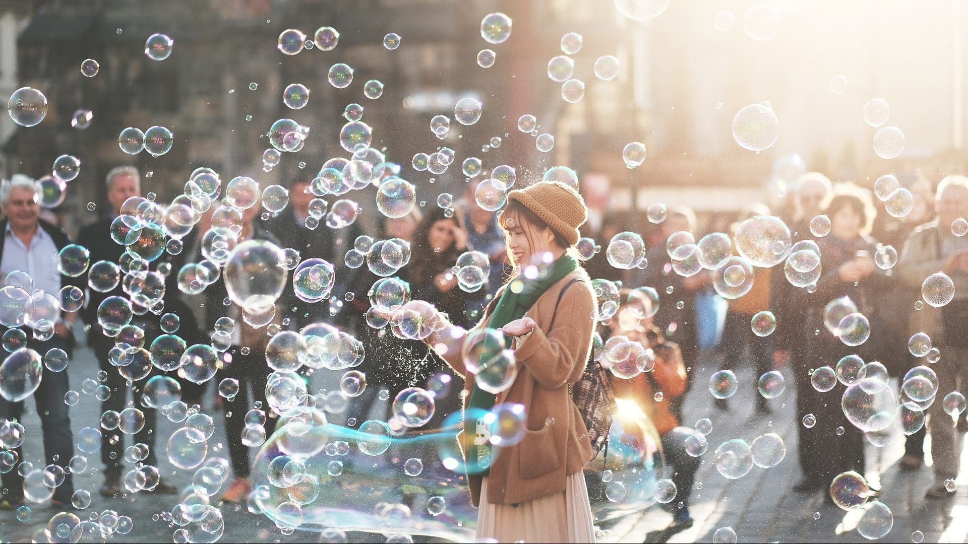 Image: a woman sanding in a cloud of bubbles