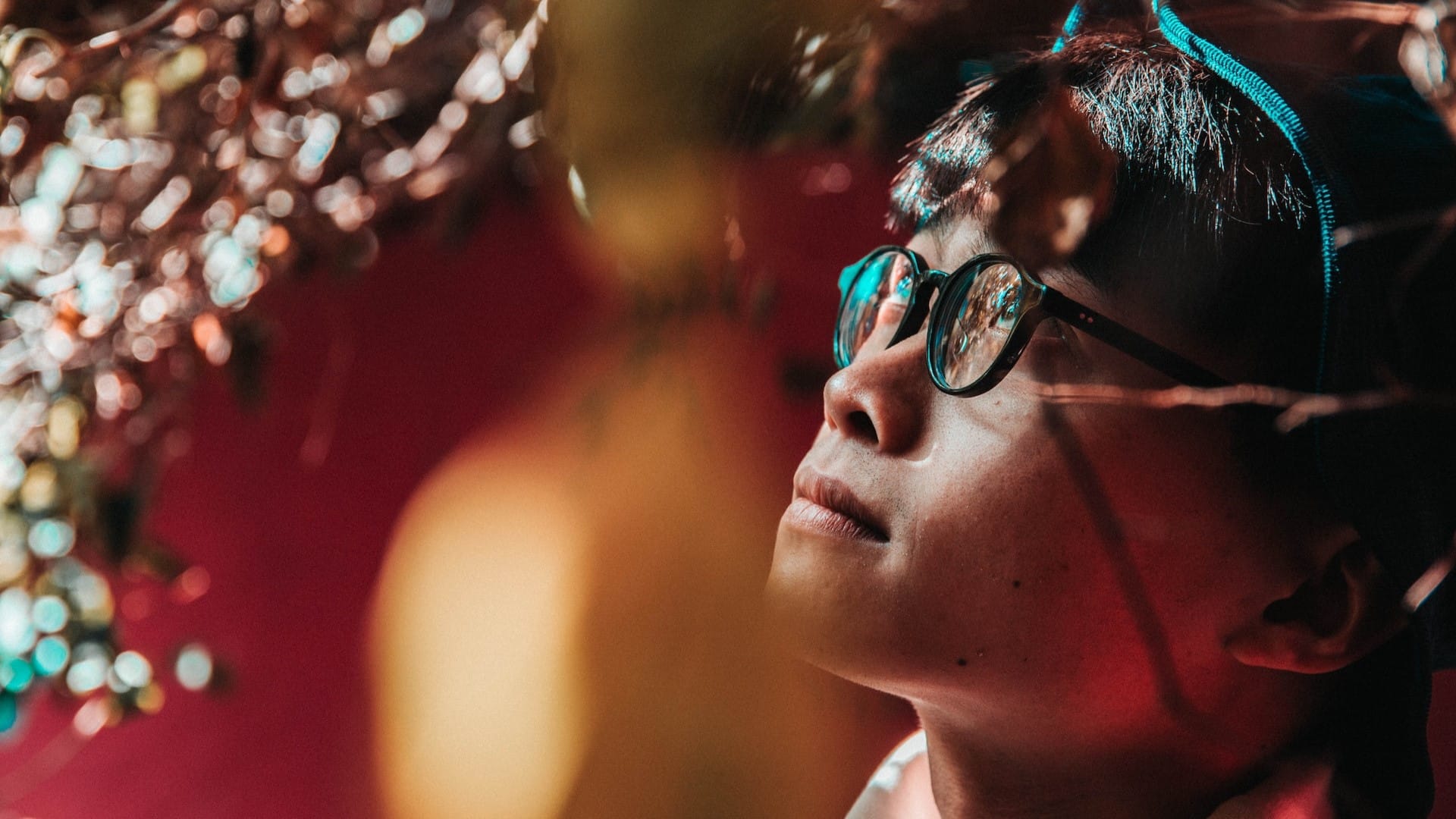 Image: A boy looking up inquisitively at some lights, exercising critical thinking skills.