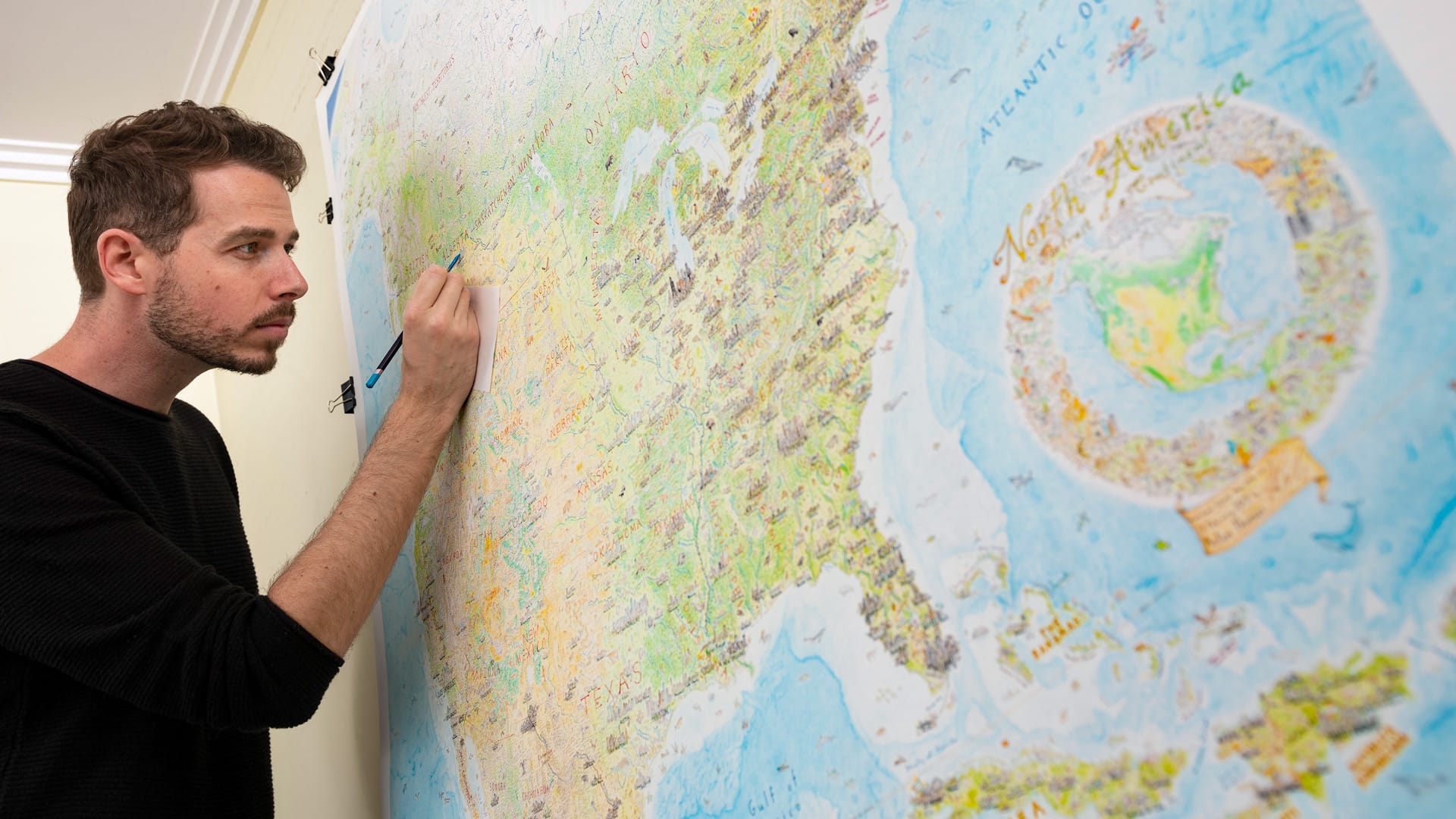 Image: Anton Thomas drawing on his map of North America