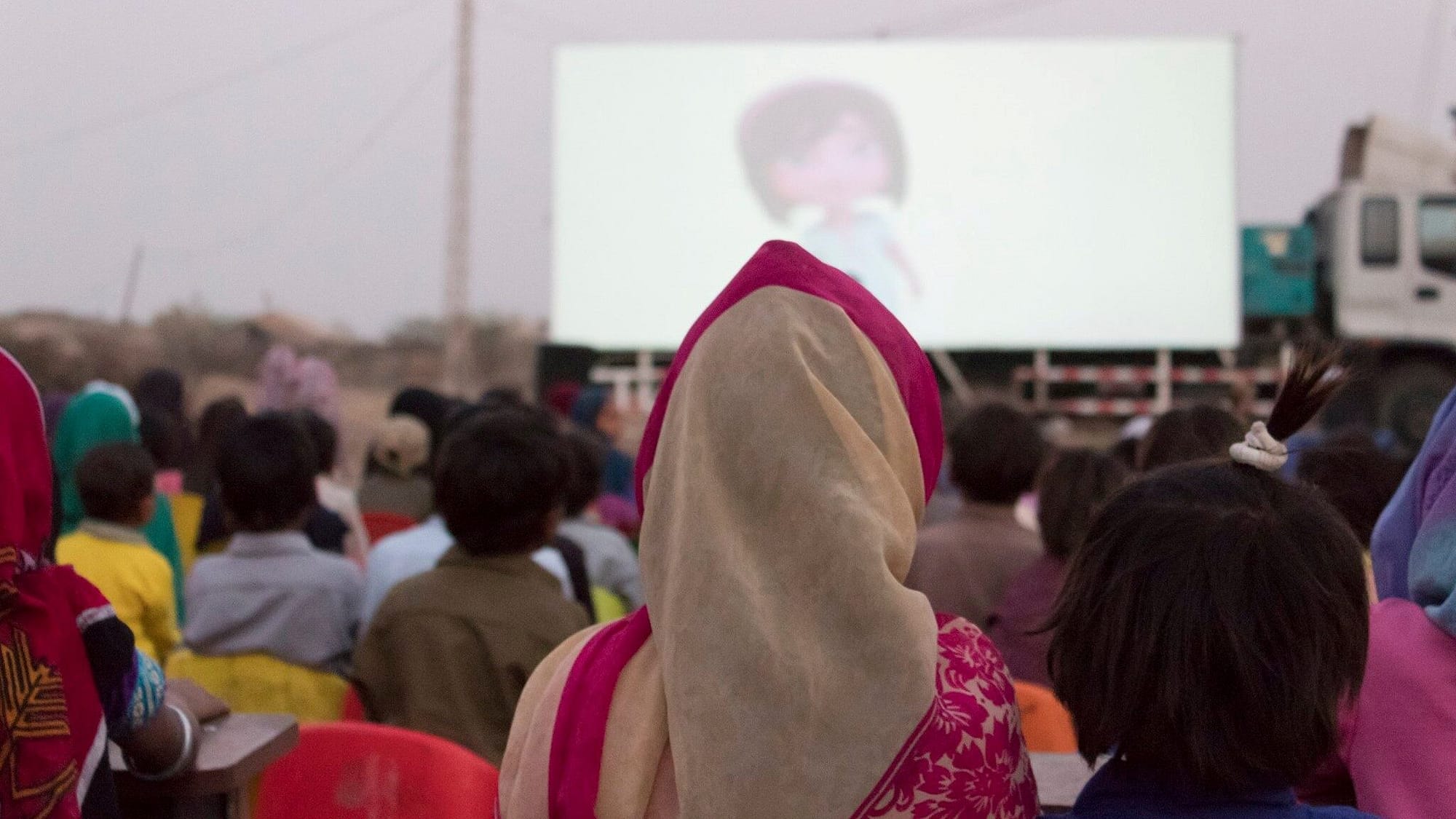 Image: People watching movie on mobile cinema