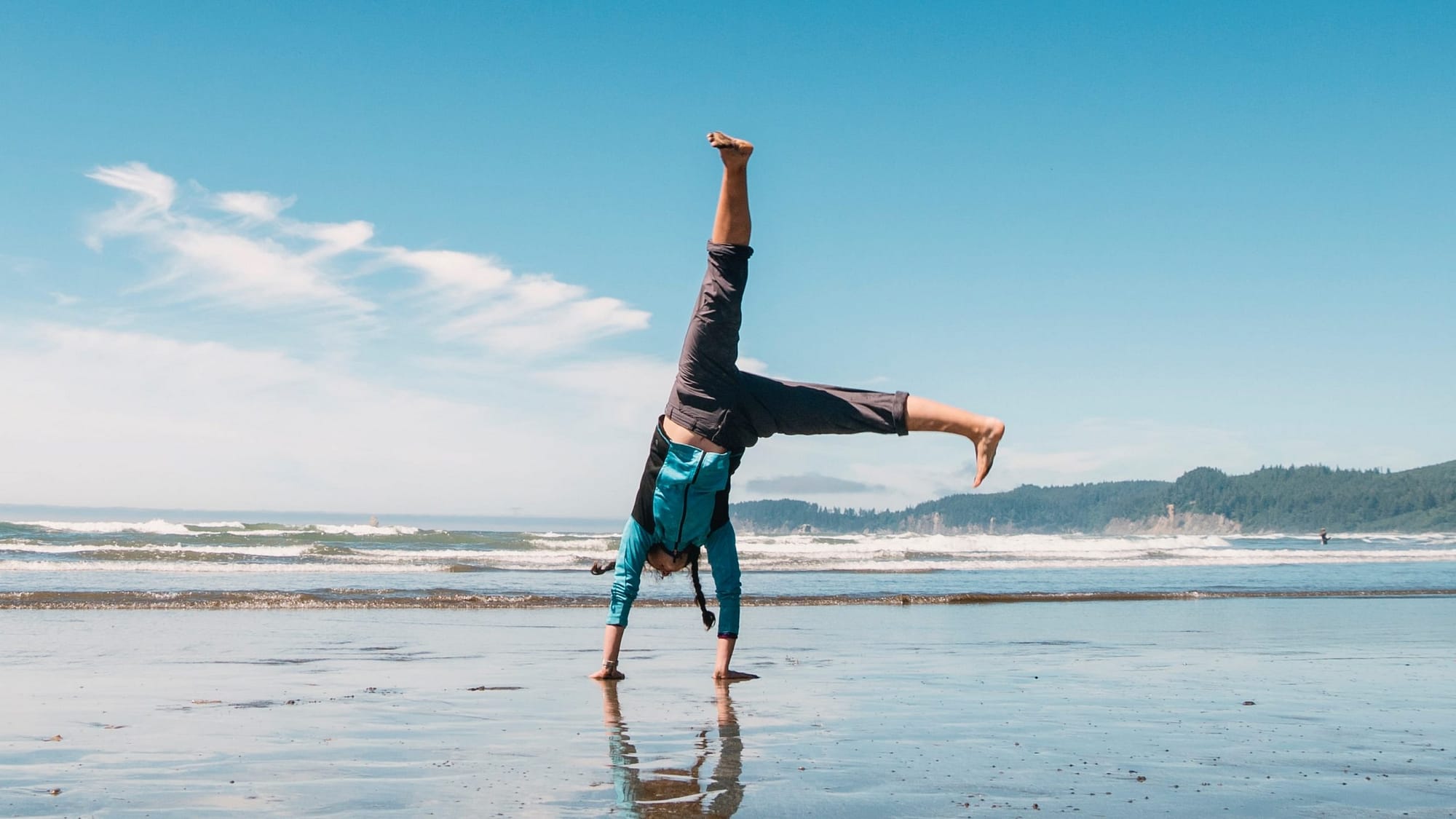 Image: A man doing a cartwheel on the beach - an example of one of the activities suggested by the algorithm to help you get out of a rut.