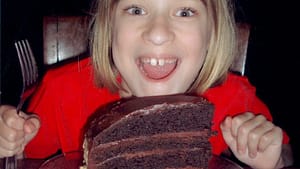 Image: young kid very excited about a giant slice ofcake!