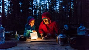 Image: Mother and child make dinner while camping