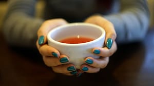 Image: Person holding a cup of tea