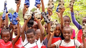 Image: Children holding pairs of The Shoe that Grows