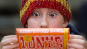 Image: A boy staring wide-eyed at a candy bar