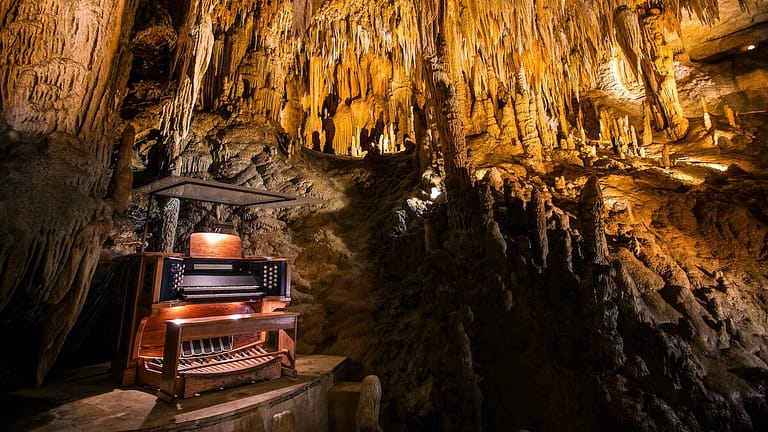 Image: organ sitting inside of a massive cave