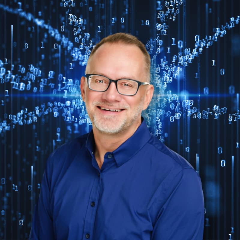 Demystifying AI with Arthur Zards: Tech Expert Arthur Zards stands in front of black background with starburst of blue digital 1s and 0s behind him