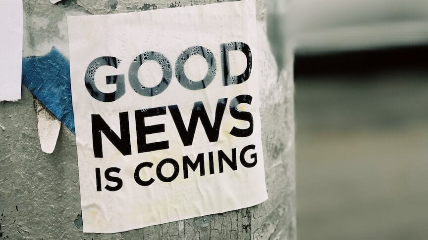 white Good News Is Coming paper on wall