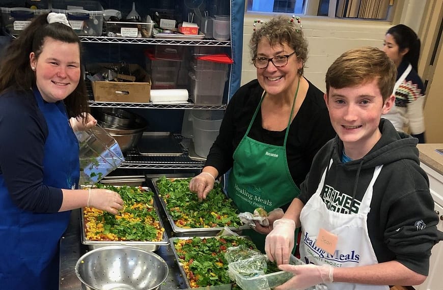 Image: young people cooking in the kitchens of the Healing Meals Community Project