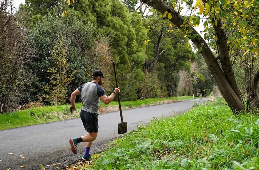 Image: Beau Miles running with a shovel during his mile an hour day