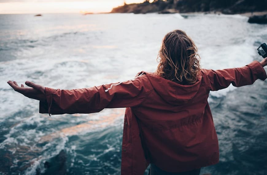 person standing near body of water