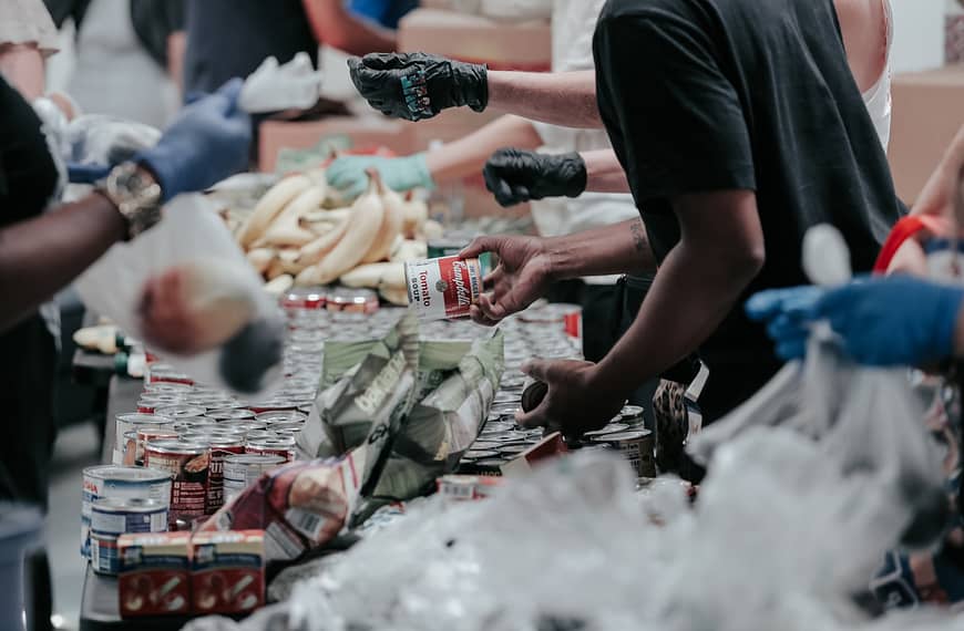 man in black t-shirt holding coca cola bottle