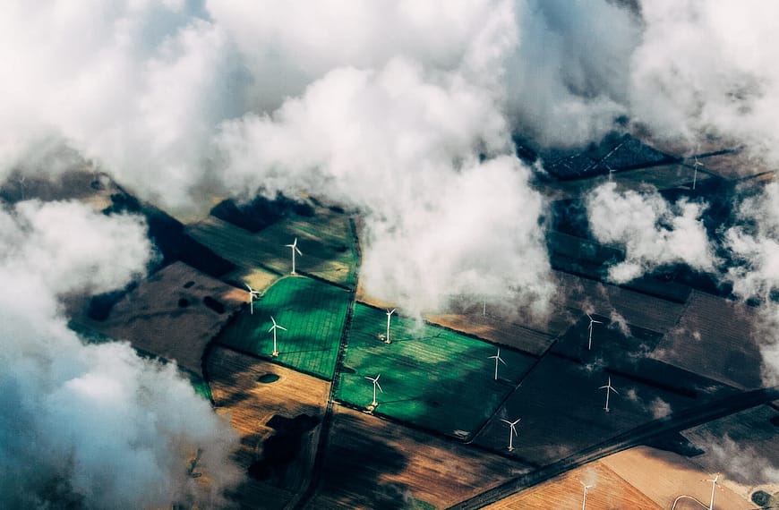 aerial photo of wind turbines near field