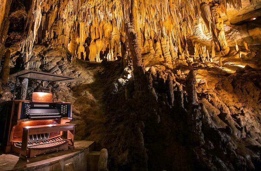 Image: organ sitting inside of a massive cave
