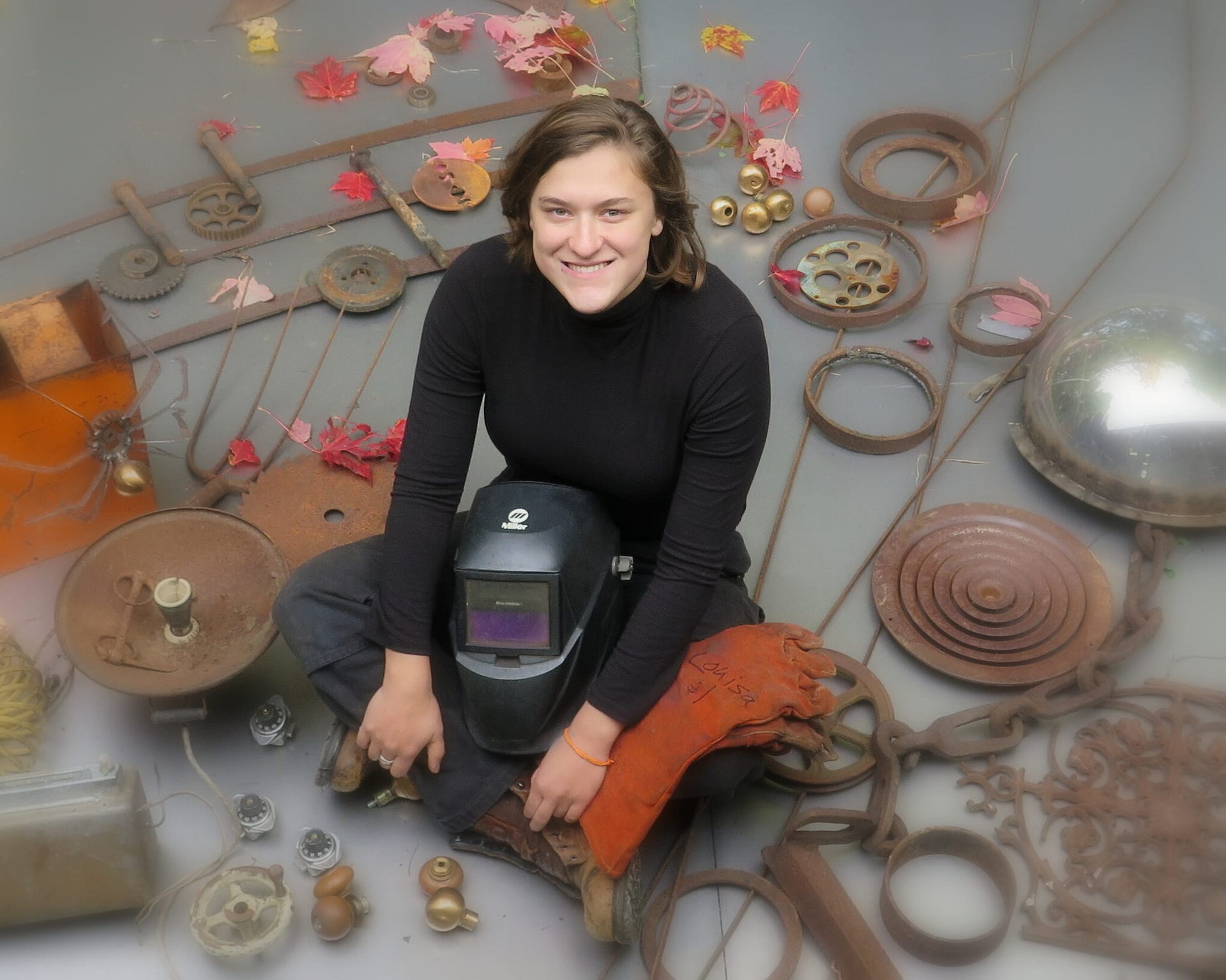 Image: Louisa sitting in the middle of rusted metal