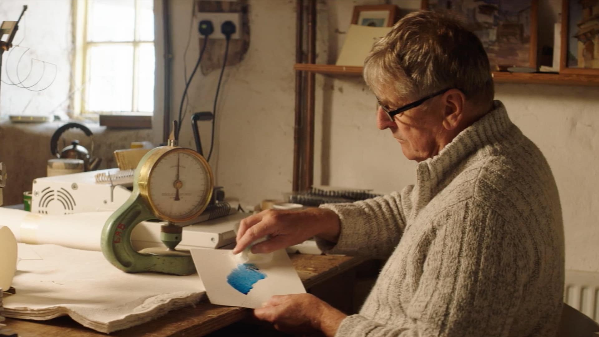 Image: man painting ink on a piece of paper
