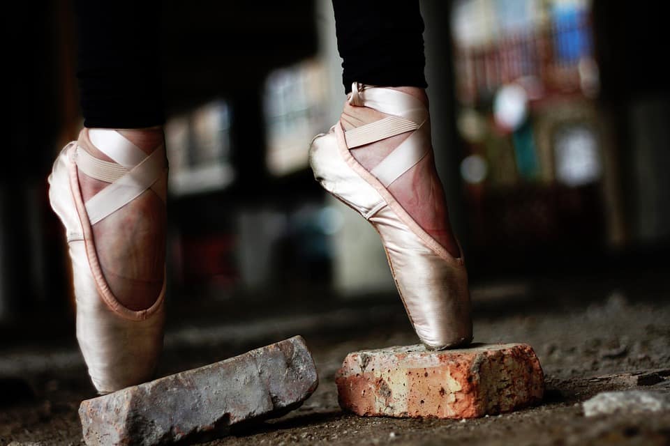 Image: Ballet dancer wearing pointe shoes on bricks