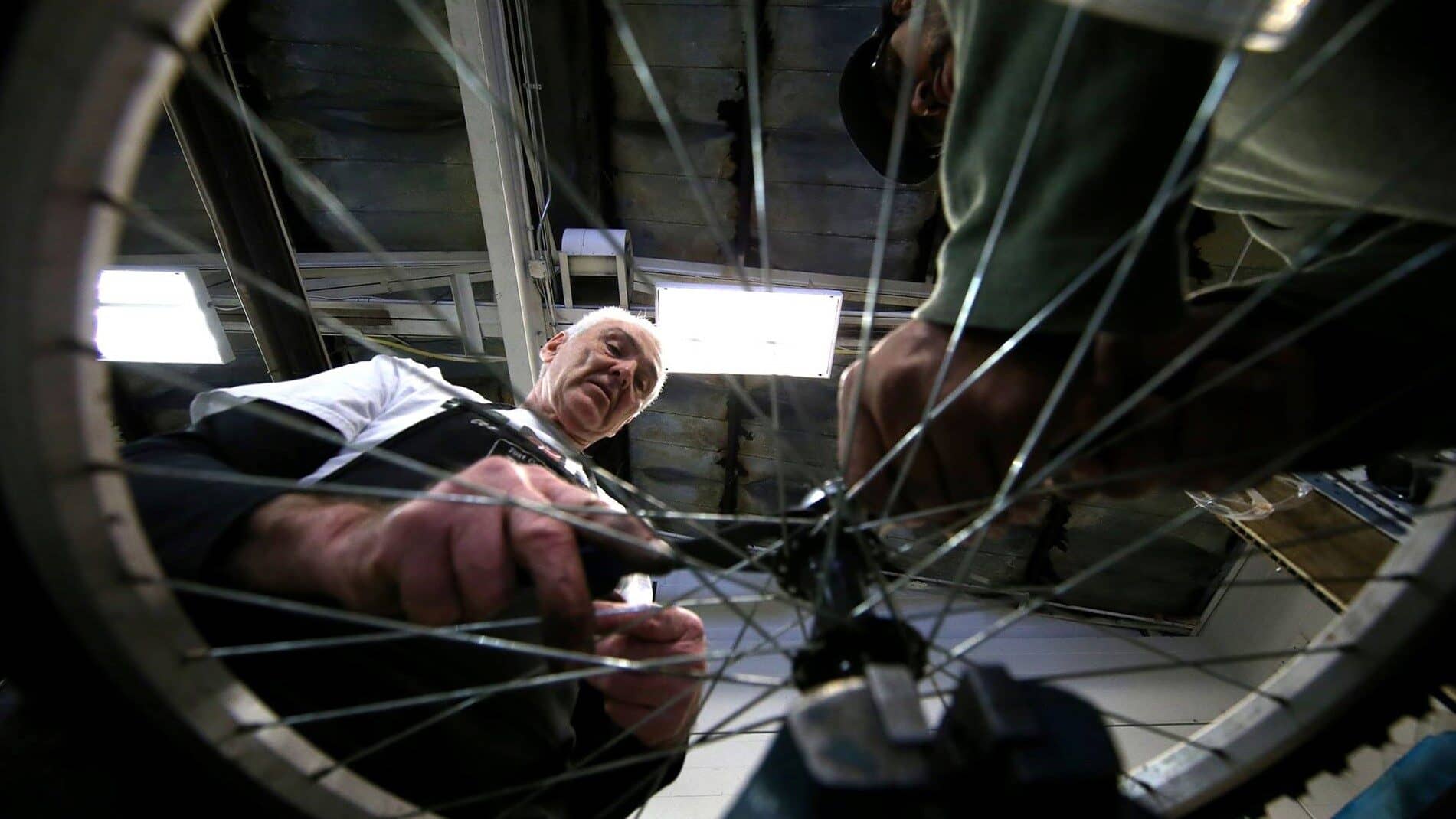 Image: older person working on a bike at the Fort Collins Bike Shop where Rafael helped build a legacy for himself with his work and kindness