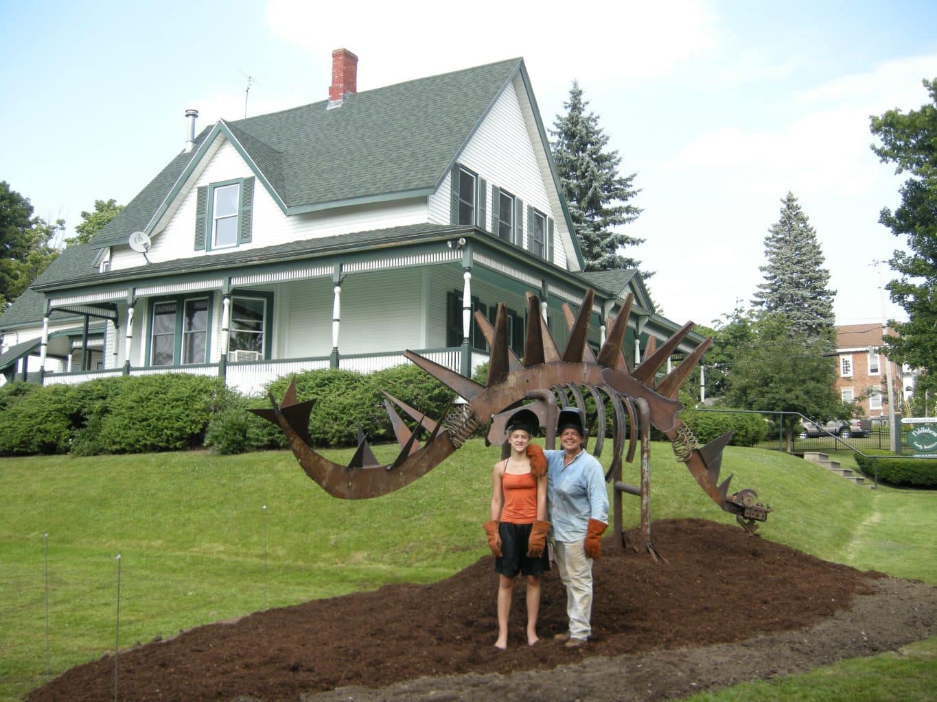Image: Louisa and Lynda next to their sculpture of a dinosaur 