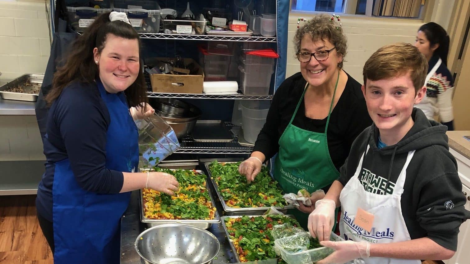 Image: young people cooking in the kitchens of the Healing Meals Community Project