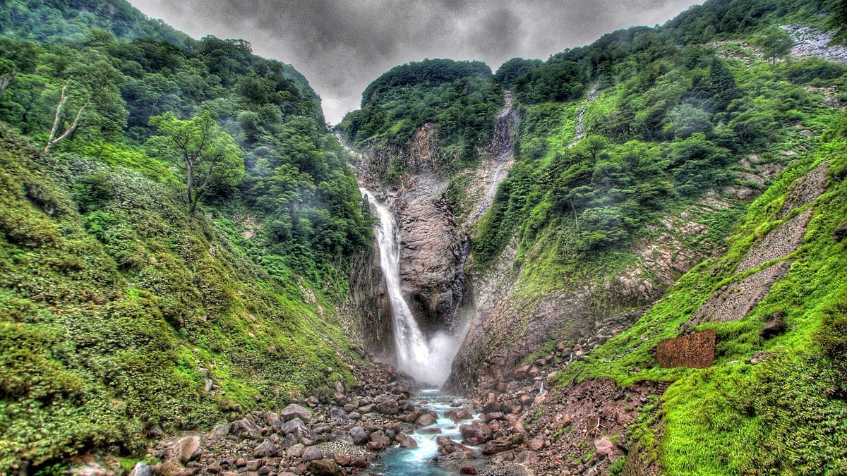 Image: Shomyo Falls, a Large waterfall in Japan running between two green mountains where Sawanobori is often practiced.