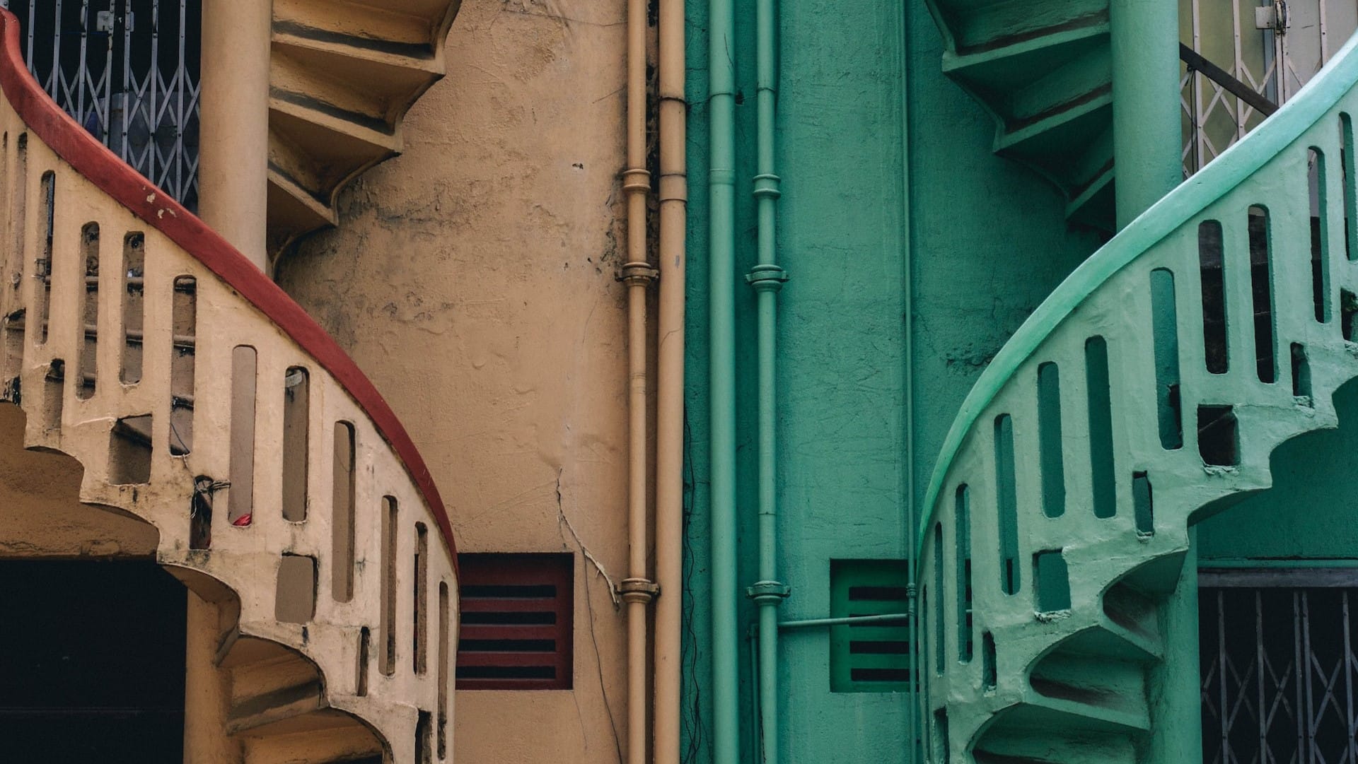 Image: Two staircases headed in opposite directions, one beige and one teal. Representing the way there can be two sides to one story.