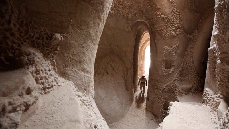 Image: "Caveman" Ra Paulette walking through one of his caves