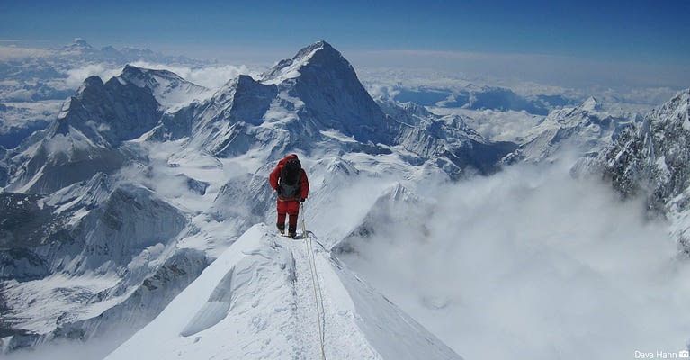 Image: a lone climber on a ridge of Everest