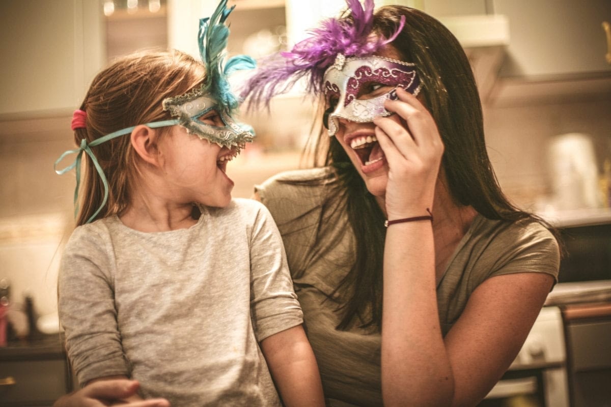 Image: mother and daughter wearing party masks, connection