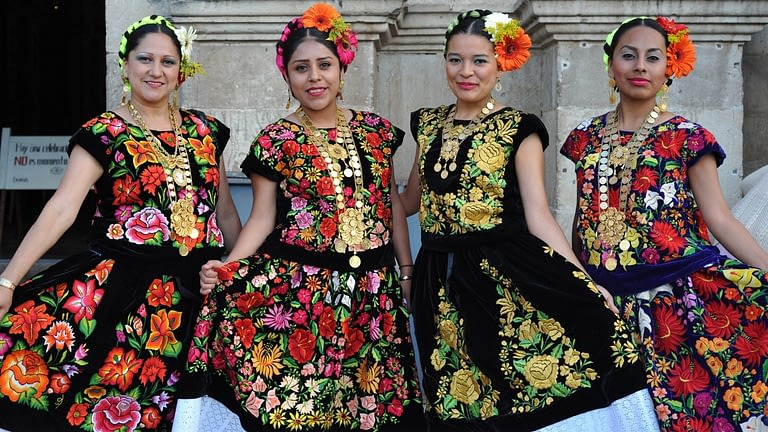 Image: women showing off their beautifully embroidered outfits