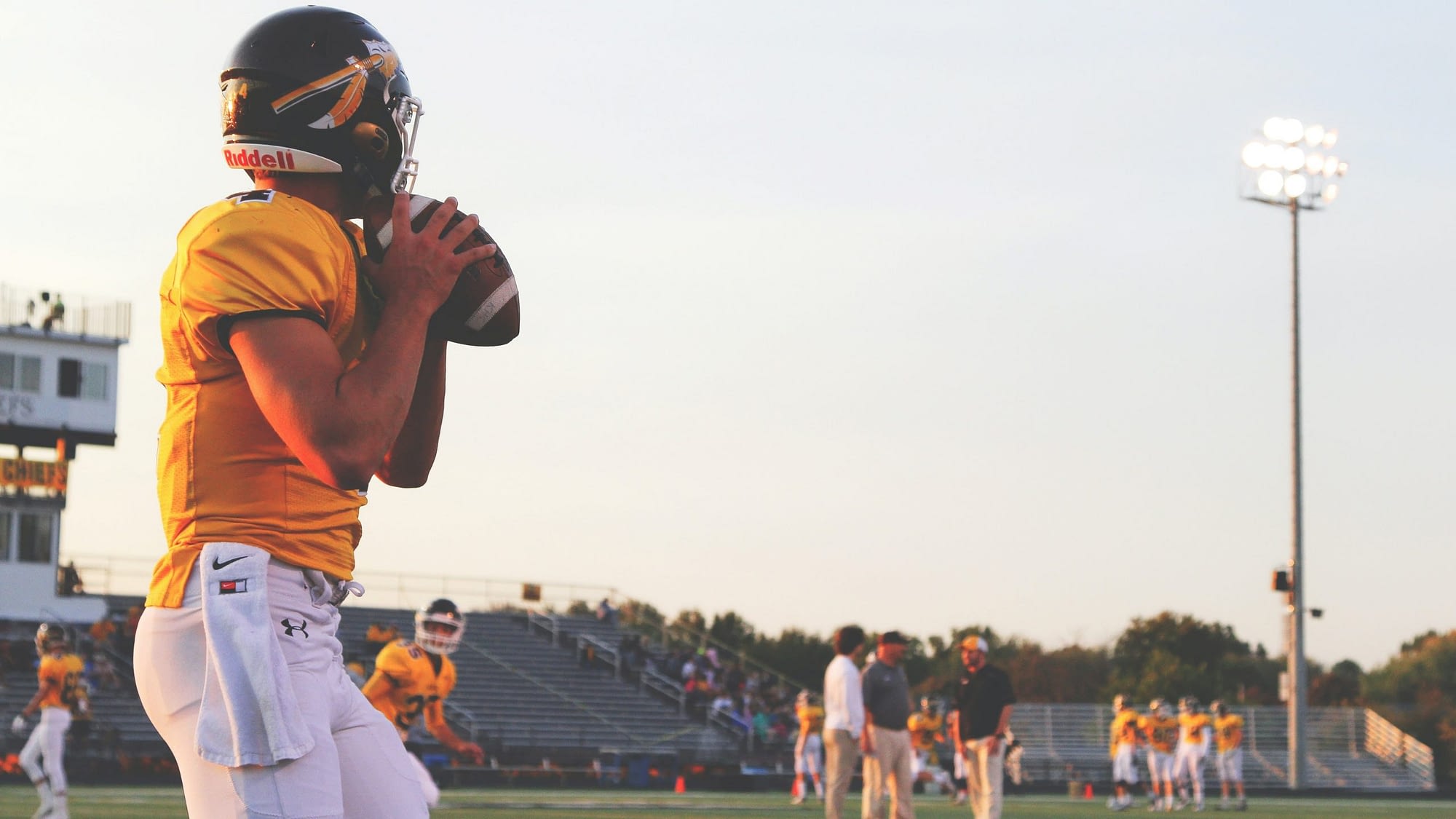 Image: A high school student preparing to throw a football to his teammates. A metaphor for purpose driven goals.