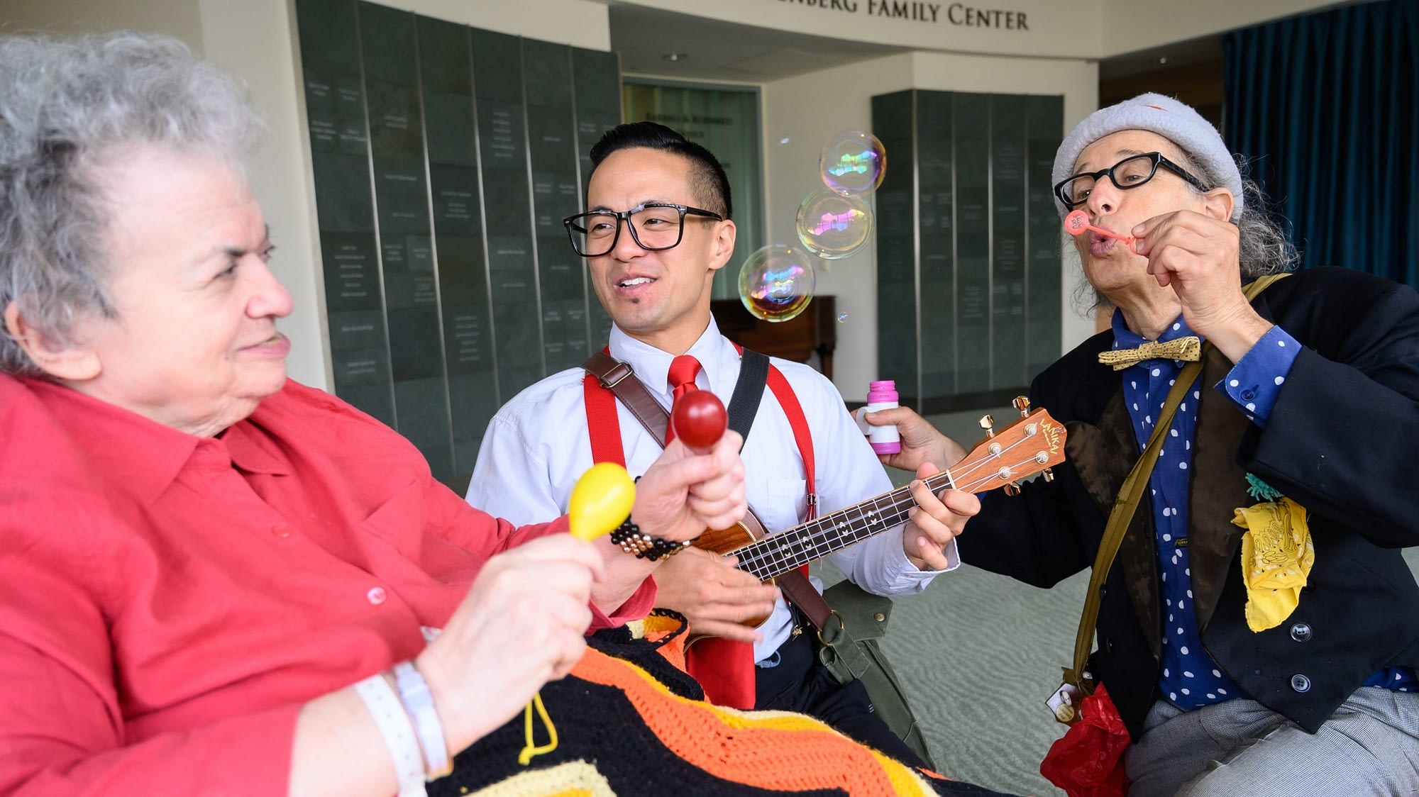 Image: Medical clowns playing music with a senior patient!