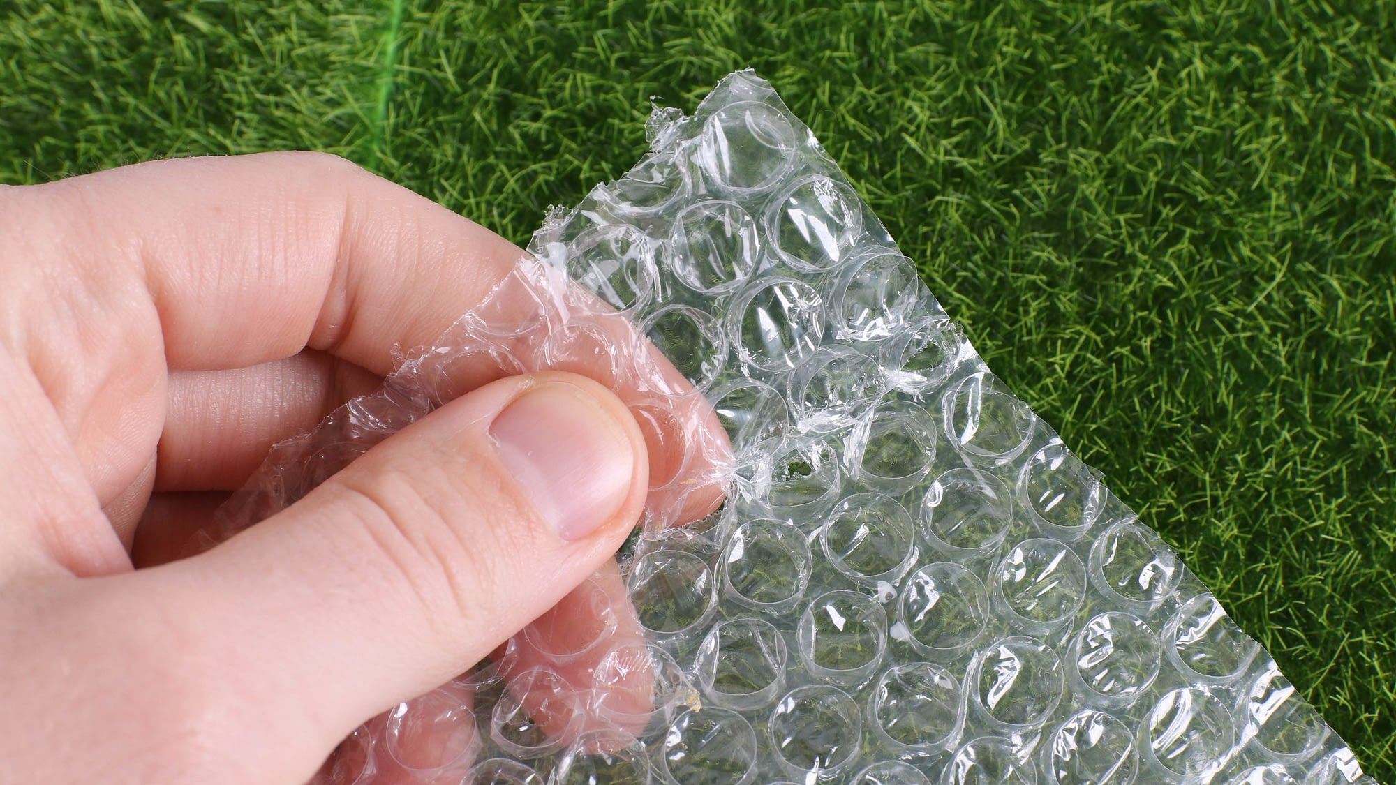 Image: Hand squeezing bubble wrap