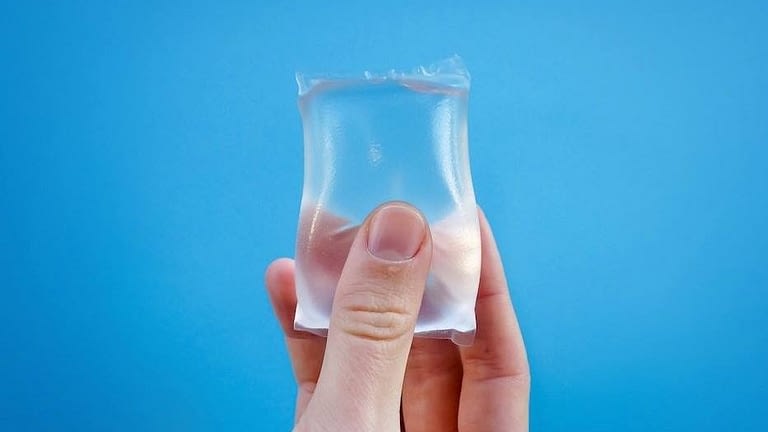 Image: a hand holding a NOTPLA water pod!