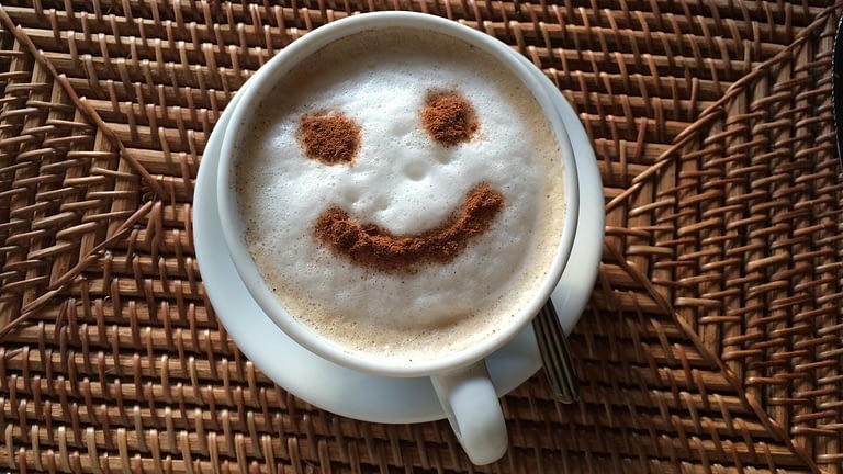 Image: Face in a cup of coffee foam smiling