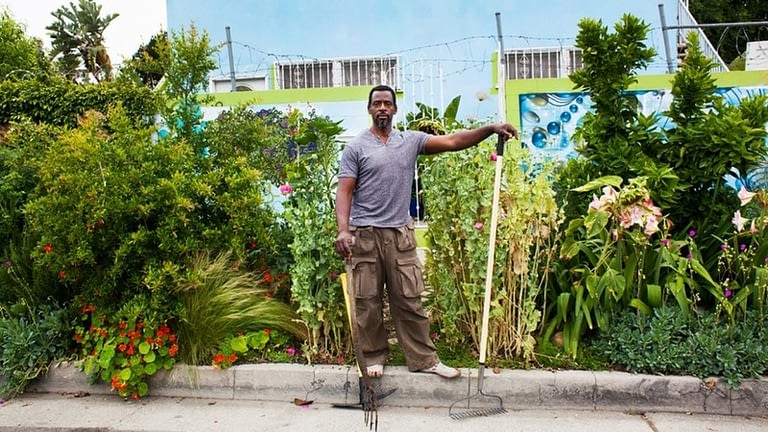 Image: Ron Finley, the Guerrilla Gardner poses in front of his garden