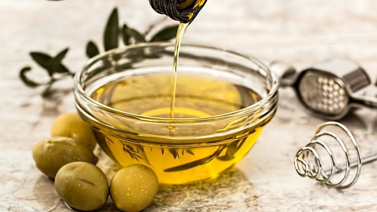 Image: Olives next to a small bowl of olive oil